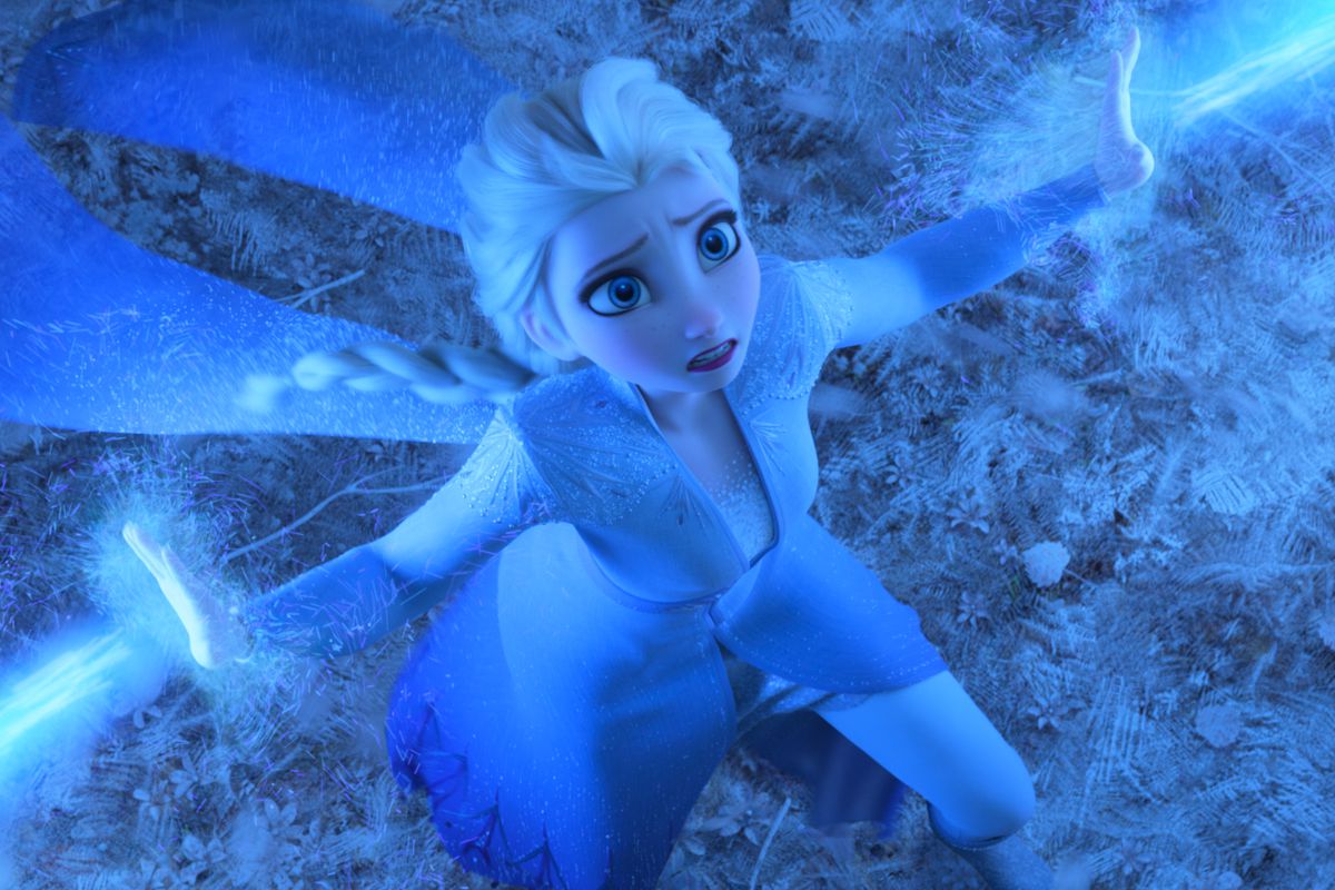 Seen from above, Queen Elsa looks frightened while using her ice powers to hold back an unseen enemy in Frozen II.
