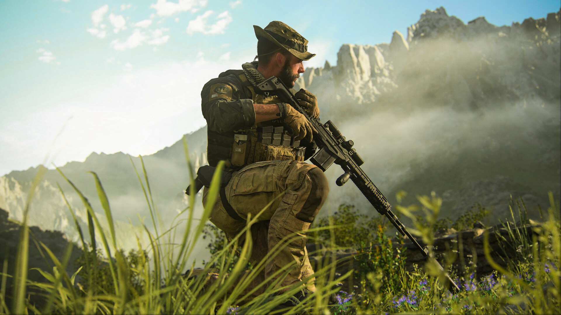 Captain Price crouches in tall grass in an open-world campaign mission in Call of Duty: Modern Warfare 3